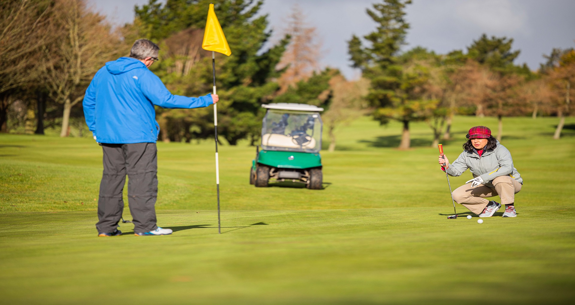 Image of a couple playing golf.